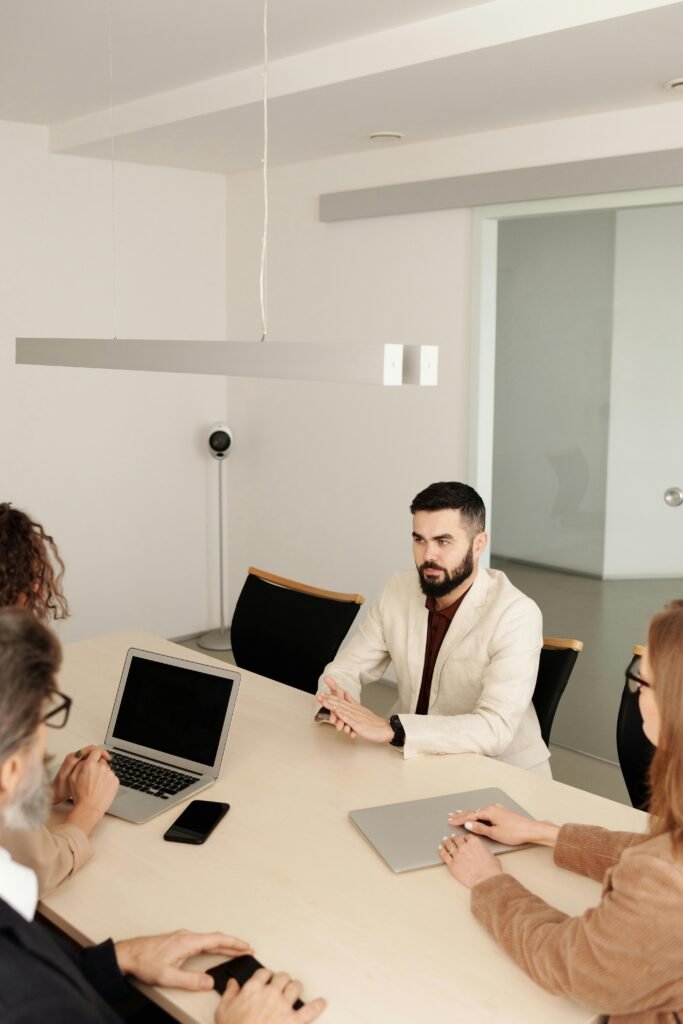 pexels-photo-4344677-4344677 Man in White Suit Jacket Sitting Having an Interview